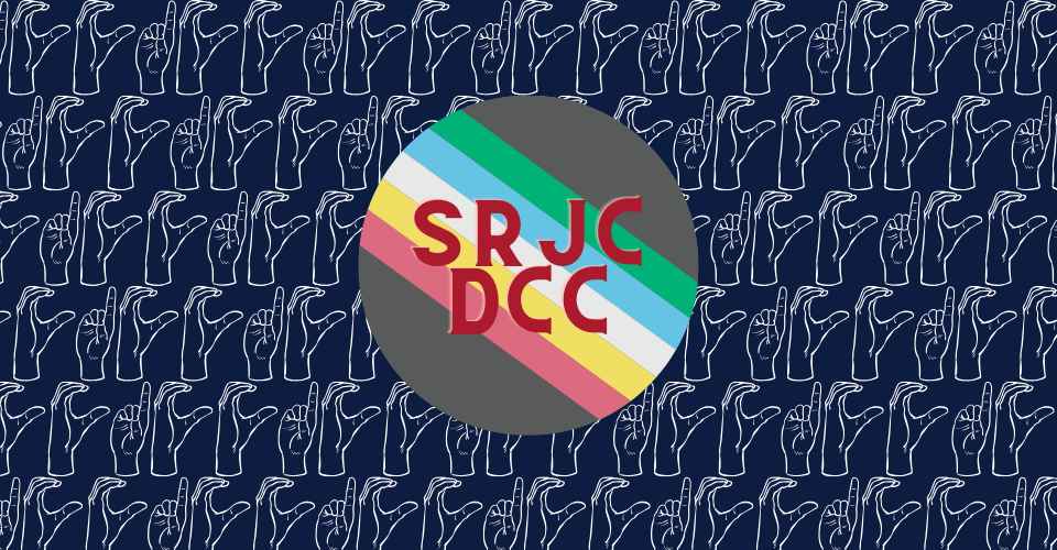 Disability Pride Flag circle with "SRJC DCC" on top in red lettering. Behind is a navy blue background with "DCC" Finger spelled in ASL